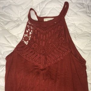 burnt orange body suit with crochet detail.